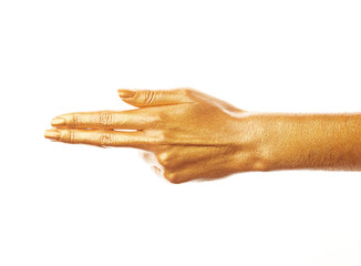 Hands in gold paint. Golden fingers. Female hand isolated on white background. White woman's hand showing symbols and gestures.