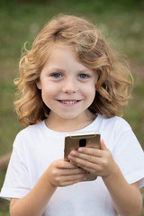 Funny child with long hair holding a mobile