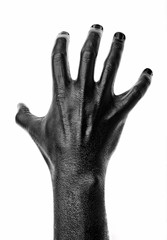 Black hand on white background, isolated, paint. ..Male hand isolated on black background. Hand showing symbols and gestures.