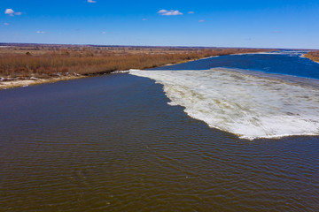 Flying drone over the ice floating on the river Oka, Russia