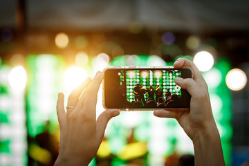 Mobile phone in hand during the shooting of a concert