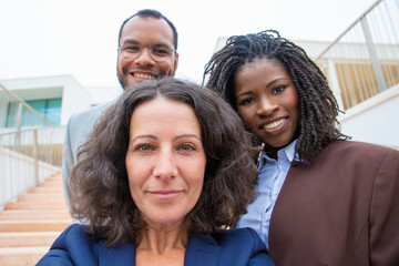 Obraz premium Cheerful multiethnic business people. Close-up portrait of happy multiracial business colleagues smiling at camera, Business team concept