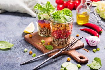 Fototapeta na wymiar Healthy quinoa and chickpeas mason jar salad, detox, diet and clean food concept, vegan snack, homemade cooking