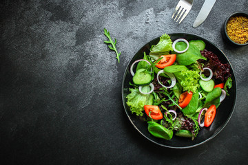 healthy salad (tomato, cucumber, mix leaves, onions and other ingredients) top menu concept. food background. copy space