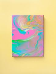 Painting in bright pastel colors on wall using liquid fluid art trendy technique. Central composition. View opposite or from above. Flat lay. Close-up. Concept contemporary art accessible to everyone