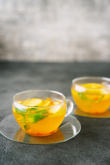 Two glass cups of fuit tea on dark background