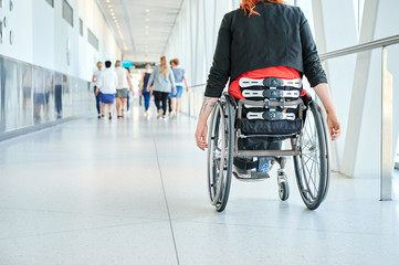 Young woman in wheelchair in a corridor