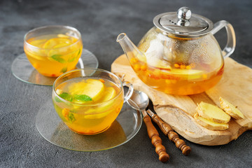 Tea set composition with hot tea on dark grey background