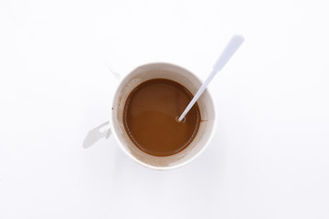 Top view of a paper cup of coffee on white background
