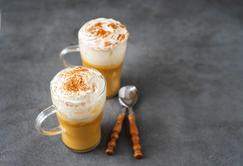 Two glass cups with spice pumpkin cappuccino