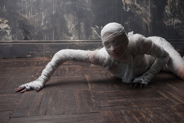 Scary mummy creeps on you. The girl with the bandage Crawling on the floor