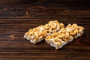  Peanut kozinaki on dark wooden background.