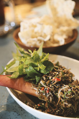 Vietnamese recipe, banana blossom spicy salad, film filter toned image.