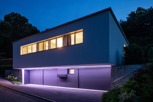 House exterior with purple lighting. Night image