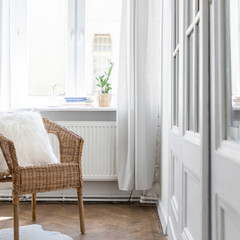 Apartment interior with wicker chair