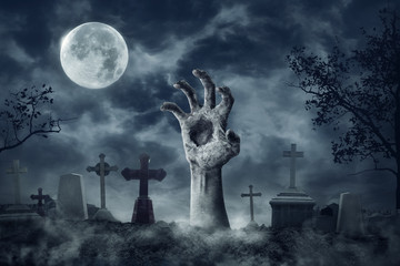 Zombie Hand Rising Out Of A Graveyard In Spooky Night