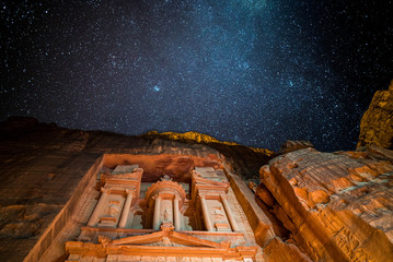 Petra treasury by night lighten by candles and galaxy - obrazy, fototapety, plakaty