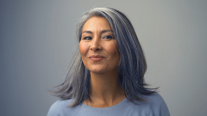Cute Middle-Aged Asian Woman Looking Aside - Powered by Adobe