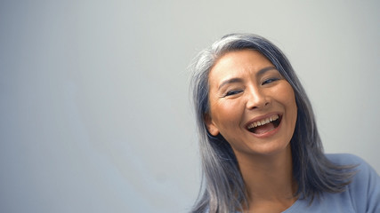 Beautiful Asian Woman Is Laughing With A Cunning Face