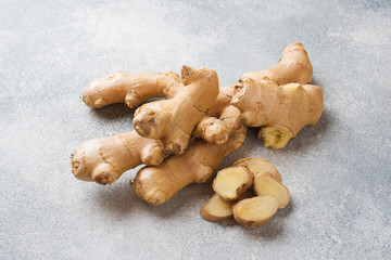 Fresh ginger root on grey background. Copy space.