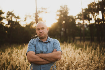 a man in the field in the grass at sunset