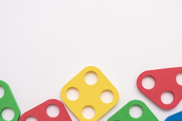 On a white background in a chaotic manner are large multi-colored children's figures. copy space.