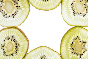 Macro photo of a beautiful delicious kiwi sliced in circles with back light on the lumen. Top view