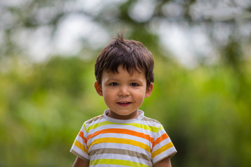 Portrait of Little Boy Smiling and Playing Outdoor