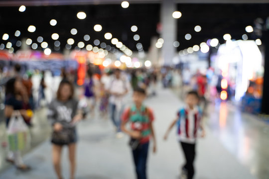 Blurred images of trade fairs in the big hall. image of people walking on a trade fair exhibition or expo where business people show innovation activity and present product in a big hall.