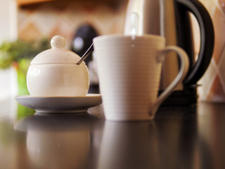 Round white sugar bowl in focus. Breakfast theme, Selective focus,