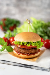 Homemade vegan burger on white rustic background