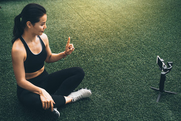  Active woman recording a tutorial with smart phone for vlog or courses online. Blogger online concept