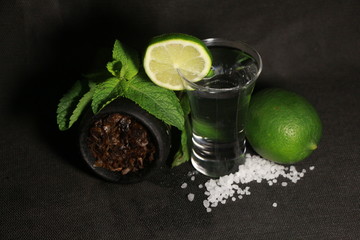bowl with tobacco for hookah. fruits on a black background