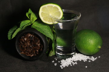 bowl with tobacco for hookah. fruits on a black background. smoking hookah