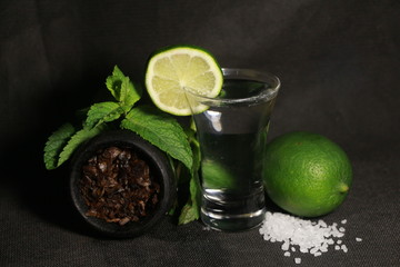bowl with tobacco for hookah. berries on a black background