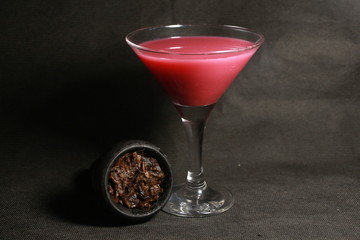 bowl with tobacco for hookah. fruits on a black background