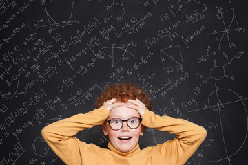 Excited surprised child boy student on science background