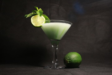 green cocktail with lime and mint