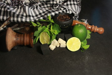 bowl with tobacco for hookah. fruits on a black background