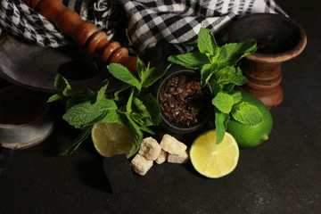 bowl with tobacco for hookah. berries on a black background