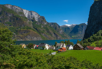 Fototapeta na wymiar Undredal, Norway - July 2019: View to the small village at the bank of the Aurland fjord in Undredal, Norway.