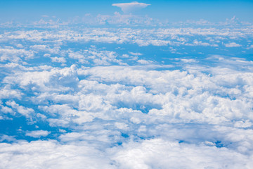 The blue sky and white clouds at an altitude of 10,000 meters under the sun