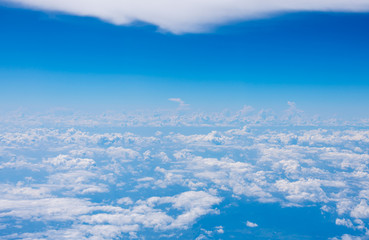 The blue sky and white clouds at an altitude of 10,000 meters under the sun