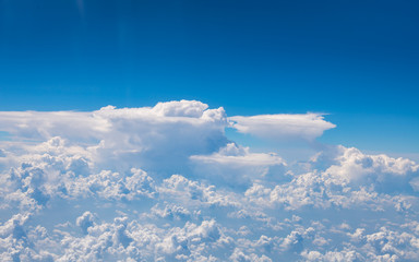 Naklejka premium The blue sky and white clouds at an altitude of 10,000 meters under the sun