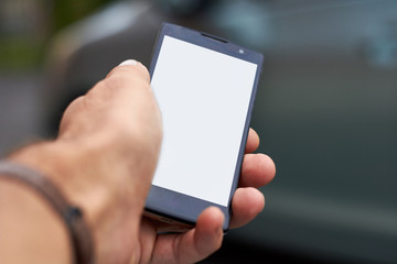 A man's hand holding a smartphone.