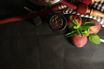 bowl with tobacco for hookah. berries on a black background