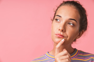Fototapeta premium Image closeup of attractive beautiful woman dressed in colorful clothes thinking and looking aside at copyspace