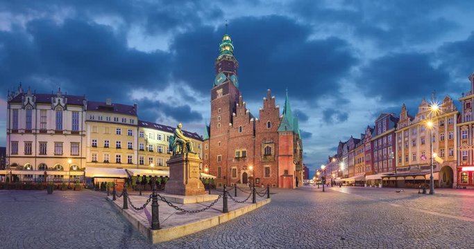 View of Rynek square in Wroclaw, Poland with gothic Town Hall and monument at dusk (static image with animated sky)