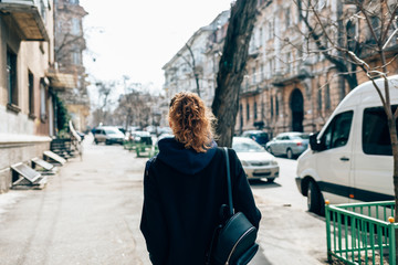 Back view young woman with curly hair