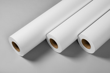 Blank white paper rolls isolated on gray background. Mockup paper for magazines, catalogs or...